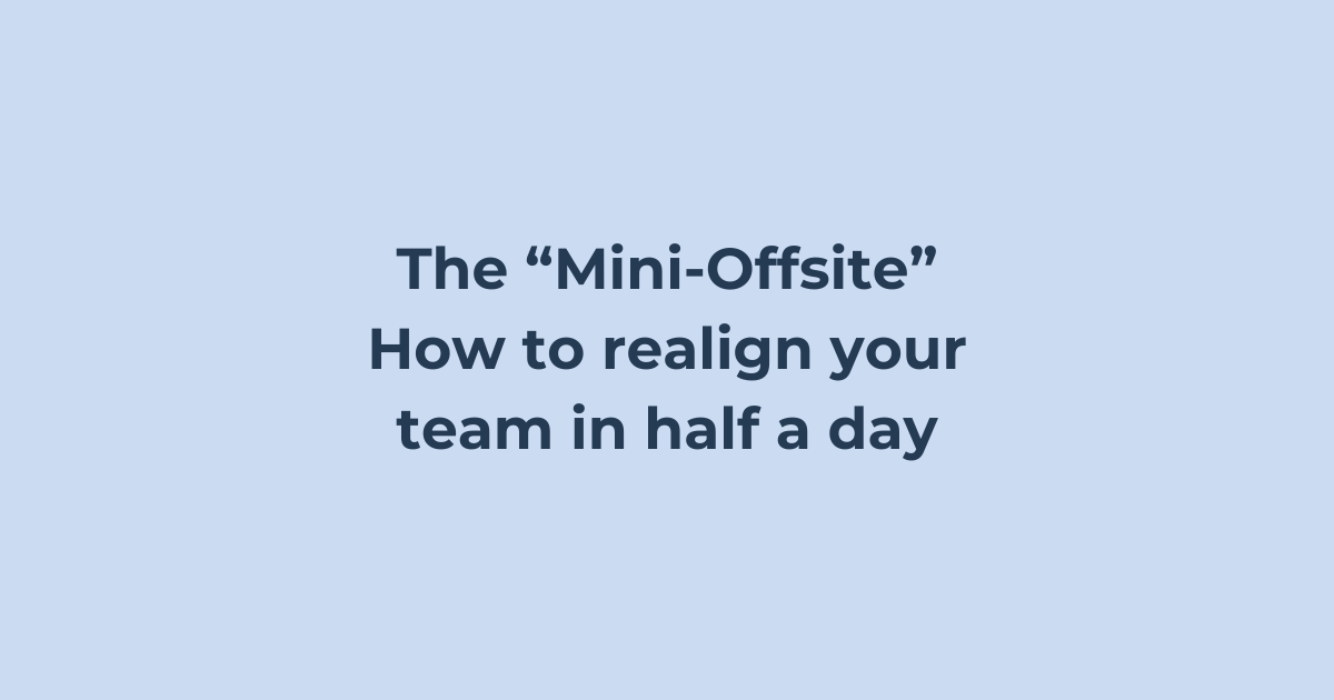 A team in discussion during a short alignment session in a meeting room.